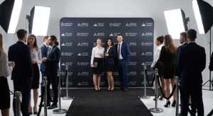 Step and repeat backdrop setup at a corporate event with anti-glare tension fabric banner and red carpet runner